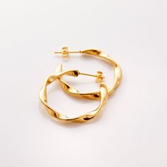 Our Ripple Hoop Earrings are inspired by the ripple effect that a pebble can cause in the ocean - these hoops stand as a reminder that you can have a ripple effect on the world with even the smallest action. Materials & Warranty Material: Real 18 karat gold plating on pure stainless steel Hypoallergenic | Sensitive Skin-Friendly Warranty: Lifetime Warranty against all rust or tarnish Packaging: Nominal Velvet Drawstring Pouch Earrings cannot be returned or exchanged due to hygienic safety Modern Twisted Jewelry For Everyday, Modern Twist Everyday Earrings, Modern Twist Hypoallergenic Hoop Earrings As Gift, Modern Twist Hypoallergenic Hoop Earrings For Gifts, Modern Twist Small Hoop Jewelry Gift, Modern Twist Small Hoop Earrings For Gift, Modern Twist Small Hoop Earrings As Gift, Modern Twist Small Hoop Hypoallergenic Jewelry, Modern Twist Hoop Earrings As Gift With Polished Finish