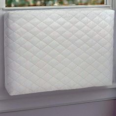 a white mattress sitting on top of a window sill