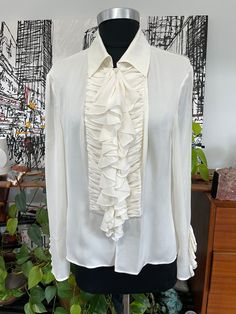 "This is a wonderful Authentic Valentino Creamy White silk Blouse Labeled a size 12- Made in Italy- 100% Silk  Button-down with ruched detailing with ruffles Ruffles and buttons on the sleeves as well  (double where applicable)                                                    bust:                38\"                     sleeves:           23\"               waist:               36\"                                                                                                                                    Long:               19 \"        Ready to Wear Please open the photos to get the true color of the Item This is a wonderful and inexpensive way to get a nice piece for a fraction of what the retail stores are asking!  CHECK OUT OUR OTHER JEWELRY, INCLUDING  CHARMS SUCH AS... VICT Valentino Blouse, White Silk Blouse, Vintage Valentino, Most Beautiful Dresses, Antique Clothing, Vintage Clothing Online, Retail Stores, White Button Down, White Silk