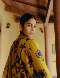 Stunning yellow mix print kurta in dupion silk, featuring a hand-embroidered neckline and sleeve hems, paired with matching printed dupion silk, pants.