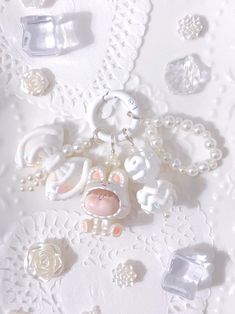 a white lace table cloth covered in jewelry