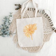 "This trendy sunflower canvas tote bag is ready to hold your towel and head to the beach or carry your book and sweater to your favorite coffee shop. This is versatile as a beach bag, school bag, grocery bag, or errand bag.  Details: - One size: 15\" x 16\"  - 20\" handle length  - 100% cotton canvas tote - Lightweight and compact - Print is on one side, the other side is blank  - The reinforced handle stitching creates a reliable bag for practicality and durability Care instructions:  - Pretrea Handmade Eco-friendly Canvas Bag For Summer, Bohemian Cotton Canvas Bag For Daily Use, Summer Beige Cotton Canvas Bag, Yellow Cotton Canvas Gift Bag, Yellow Cotton Tote Canvas Bag, Yellow Cotton Canvas Tote Bag, Yellow Cotton Canvas Bag For Summer, Yellow Eco-friendly Cotton Bag, Bohemian Summer Canvas Bag