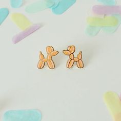 Delight your balloon enthusiast with our adorable Balloon Dog Earrings. Crafted from hard enamel, these gold-plated brass earrings radiate charm. Nickel-free for sensitive skin. Each earring stands 0.75” tall and 0.75” wide. Gift joy and style today! Trendy Hypoallergenic Enamel Earrings, Gold Hypoallergenic Novelty Earrings, Novelty Gold Hypoallergenic Earrings, Playful Gold Hypoallergenic Earrings, Playful Hypoallergenic Gold Earrings, Playful Gold Earrings, Playful Gold Enamel Earrings, Playful Gold Single Earring, Playful Gold Earrings For Gift