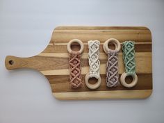 four wooden rings are tied together on a cutting board