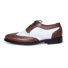 Looking for something that speaks classy? These dual toned oxford shoes should be the perfect fit for your taste. Manufactured using high- quality genuine leather; these pair of shoes carry a distinctive brogue wing-tip design perfect for flaunting at any formal event such as weddings or business gatherings. This product undoubtedly reflects its worth with the unique color contrast of rich coffee brown & white along with its specific finesse and detailed designing on the border of the shoes. The inner soles of the shoes are also lined with leather making for a comfortable, cozy fit throughout the day. Some features of the product that highlight its worth include: Use of premium leather Unique color combination of coffee and white Fashionable brogue wing-tip design Leather padding on the in Elegant White Wingtip Lace-up Shoes, White Brogue Dress Shoes For Business, White Wingtip Oxfords For Office, White Wingtip Dress Shoes For Office, Formal White Dress Shoes With Brogue Detailing, White Brogue Dress Shoes For Formal Occasions, White Dress Shoes With Brogue Detailing For Formal Occasions, White Wingtip Oxfords With Brogue Detailing, White Wingtip Lace-up Shoes For Business