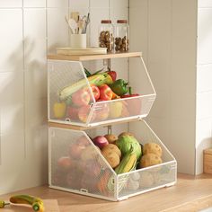 two baskets filled with fruits and vegetables on top of a counter