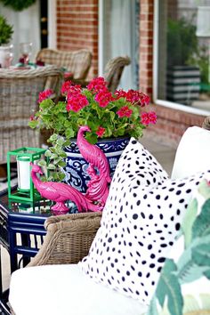 the patio is decorated with colorful flowers and potted plants