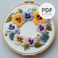 an embroidery pattern with flowers on it