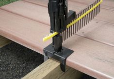 a close up of a wooden bench with metal bars attached to it