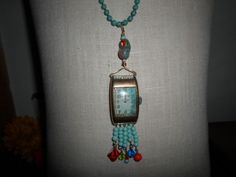 "~ I made this set and fell in love with it. It is one of my favorite pieces. It is made of an vintage (man's) watch face (non working). Inside the watch is patina, which is a green color and was the inspiration in my color choices. I added clear seed beads and a beautiful art glass bead at the top. All the beads are vintage and glass. On the bottom of the necklace I hung several turquoise colored beads and a different color and kind off each section. The chain is also vintage, maybe from the 80 Teal Glass, Vintage Picture Frames, Metal Ball, Red Bead, Copper Color, Turquoise Color, Necklace Earring Set, Ball Chain, Necklace Earrings