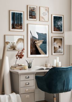 a desk with pictures on the wall above it