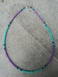 This choker features teal, black and purple seed beads. Purple Seed Beads Necklace, Adjustable Purple Beaded Choker, Purple Single Strand Beaded Necklace, Purple Beaded Jewelry, Purple Multi-strand Beaded Necklace, Adjustable Multi-strand Purple Beaded Necklaces, Turquoise And Purple, Beads Bracelet Design, Seed Bead Necklace