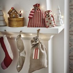 christmas stockings hanging from hooks on a shelf