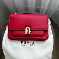 Furla Wonen Handbag 1927. Crossbody In Pop Red/Berry Color. Made In Elegant Leather With Featuring Chain Inserts. I Wore It Once. The Condition Is Perfect. Kept It In Holder. Length 10” ( 25cm) Width: 6 1/2” ( 17) Diagonal: 12” ( 30cm) Furla 1927, Furla Bags, Berry Color, Women Handbag, Berry, Women Handbags, Genuine Leather, Bag Lady, Handbags