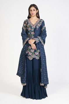 Navy blue kurta with all over floral pattern and multi color thread embroidery. Paired with sharara with intricated pleated panel and polka dot woven pattern dupatta.
Components: 3
Pattern: Embroidered and Woven
Type Of Work: Thread Work and Polka Dot Pattern
Neckline: V Neck
Sleeve Type: Full Sleeves
Fabric: Raw Silk, Georgette, Silk
Color: Blue
Other Details: 
Embroidered dupatta border
Side slits on kurta
Cut work hem details
Occasion: Wedding,Sangeet - Aza Fashions Blue Chinon Kurta With Intricate Embroidery, Unstitched Floral Embroidery Sharara, Blue Chinon Kurta With Chikankari Embroidery, Blue Anarkali Sharara With Floral Embroidery, Blue Chinon Sharara With Intricate Embroidery, Blue Chikankari Embroidery Palazzo Set For Reception, Blue Chikankari Embroidered Sharara For Reception, Blue Palazzo Set With Chikankari Embroidery For Reception, Blue Sharara With Floral Embroidery In Traditional Drape