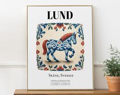 a poster with a horse on it sitting next to a potted plant and wall