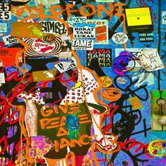 a collage of various stickers and graffiti on a wall with the word love peace dance