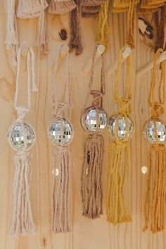 there are many different colored beads hanging on the wooden wall with mirrors in them and one has a string attached to it