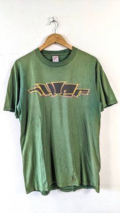 Size : L  Armpit : 21 inch  Length : 29 inch  Made in USA Good vintage condition Notes :  Please leave your phone number & email address after made a purchase. It is for shipment process Thanks for viewing  Feel free to ask ! Y2k Green Graphic Print T-shirt, Retro Green T-shirt For Streetwear, Green Y2k T-shirt For Streetwear, Green Retro T-shirt For Streetwear, 90s Green T-shirt For Streetwear, 90s Style Green T-shirt For Streetwear, Retro Green T-shirt With Logo Print, 90s Green T-shirt With Logo Print, Vintage Green T-shirt With Graphic Design