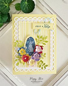 a handmade card with flowers on it and a green plant in the background that says just nite