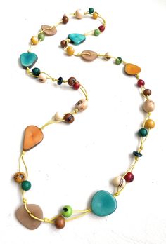 Multi-Color Tagua Long Necklace Ecuadorean Tagua Jewelry - Eco Friendly Color: Multi-Color Part Number: TAG541 Item Weight: .65oz Product Length: 35 inches long About Tagua This Product is handcrafted from a palm tree nut native to the lush tropical rainforests of Ecuador. Also referred to as the Ecuadorean Ivory Palm, the Tagua tree produces several bushels of seed pods a year with up to 100 Tagua nuts per pod. These nuts are then harvested, dried, and crafted into a wide range of products from Ivory Necklace, Tagua Jewelry, Tagua Nuts, Tree Nuts, Tropical Rainforest, Lia Sophia, Seed Pods, Necklace Long, Ecuador