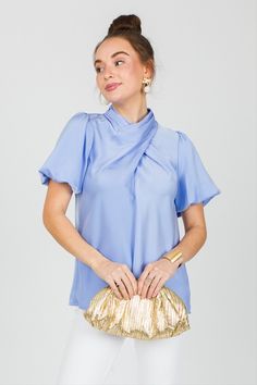 This stunning satin smooth blouse features an elegant wrapped neckline and puffed short sleeves. We love this for the office, date night, or even the holidays! Blouse has triple button closures on the back of the neck. Chic Blouse With Puff Sleeves, Elegant Blouse For Night Out, Satin Puff Sleeve Tops For Work, Satin Puff Sleeve Tops For Night Out, Chic Fitted Puff Sleeve Short Sleeve Top, Chic Fitted Short Sleeve Puff Top, Feminine Satin Tops For Work, Feminine Satin Tops For Workwear, Chic Fitted Short Sleeve Top With Puff Sleeves