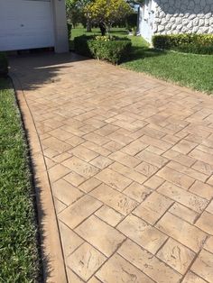 a brick walkway in front of a house