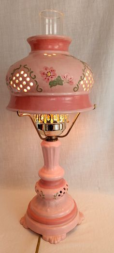 a pink lamp sitting on top of a table