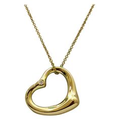 TIFFANY & Co. Elsa Peretti 18K Gold 2 Diamond 22mm Open Heart Pendant Necklace Metal: 18K Yellow Gold Weight: 7.80 grams Chain: 16" long Pendant: 22mm wide, medium size Diamond: 2 round brilliant diamonds, 1 on front side, 1 on back side, carat total weight .08 Hallmark: "TIFFANY&Co. ©Elsa Peretti 750 SPAIN" on pendant, "TIFFANY&CO. 750 ©PERETTI SPAIN" on chain tags Condition: Excellent condition, comes with Tiffany pouch and box Limited edition, no longer available for sale in Tiffany stores Au Luxury Gold Heart Pendant Necklace, Classic Gold Heart Necklace For Formal Occasions, Gold Necklaces With Polished Finish For Valentine's Day, Luxury Open Heart Necklace For Anniversary, Formal Yellow Gold Heart Necklace For Valentine's Day, Formal Yellow Gold Double Heart Necklace, Luxury Yellow Gold Heart Pendant Necklace, Luxury Gold Diamond Heart Necklace, Gold Diamond Luxury Heart Necklace