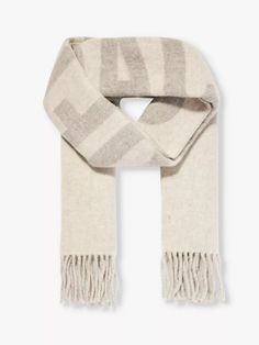 "Translating simply to """"the scarf"""", the L'echarpe is the latest Jacquemus piece to drop – and, no doubt, it's captured everyone's attention. An oversized, rectangular style woven from pure virgin wool, it's uber-soft and cosy to lock out the trans-seasonal cold and comes with the brand's name in bold lettering. If we weren't impressed with Creative Director Simon Porte Jacquemus before, we certainly are now." Simon Porte Jacquemus, Back To Uni, Wool Knit Scarf, Lock Out, Bold Lettering, Jacquard Knit, Knit Scarf, Creative Director, Knitted Scarf