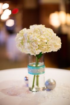 a vase filled with white flowers on top of a table