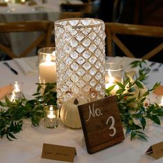 the table is set with candles and place cards