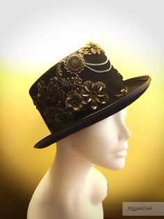 "Neo-Victorian top hat combining a vintage Victorian style with subtle eccentricity of mechanical aesthetic of steampunk, this unisex top hat is fitted with a variety of Victorian vintage baubles and fantastical cogs & gear ornaments on a formed Felt hat with with Ribbon Band. Choosing the custom theme Hat option? Whether you are a high-society aristocrat, a brilliant Steam engineer or a greasy Steam-machine mechanic, your customized hat will work wonderfully with almost any ensemble. S I Z Steampunk Fitted Brimmed Top Hat, Steampunk Top Hat With Curved Brim For Costume, Black Steampunk Top Hat For Alternative Fashion, Gothic High Crown Top Hat, Gothic Top Hat With High Crown, Gothic Fitted Top Hat With High Crown, Gothic Fitted Hat With Curved Brim, Gothic Fitted Hats With Curved Brim, Victorian Adjustable Top Hat With High Crown