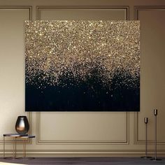 an abstract painting with gold glitters on black and white background in a living room