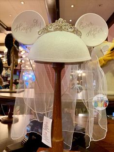 a white hat with a tiara on top of it in a store display case