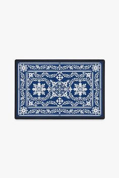 a blue and white rug with an ornate design on the bottom, in front of a white background