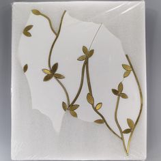 a white plate with gold leaves on it