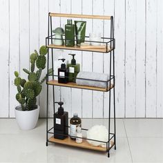 three tiered shelving unit with soap, lotion and other bathroom items on it