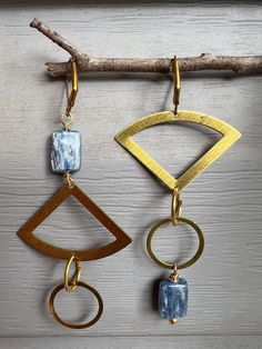 Brass components with blue kyanite gemstones mismatched creating a unique statement pair of earrings. Lightweight and airy, they are comfortable in the ear. Brass nickel-free lever backs are attached.  Earrings dangle 3 1/2" long. All jewelry will be artfully packaged for immediate gift giving. Blue Brass Earrings With Natural Stones, Blue Earrings With Natural Stones, Attached Earrings, Blue Kyanite Jewelry, Brass Jewellery, Kyanite Jewelry, Brass Components, Earrings Aesthetic, Greensboro Nc