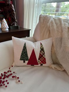 the pillows are decorated with christmas trees on them