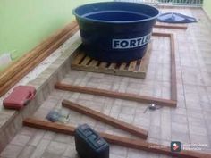 a blue bucket sitting on top of a wooden pallet