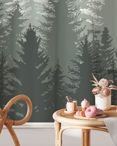 a room with a table, chair and wallpaper that has pine trees on it