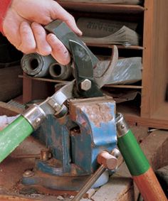 a person is using a green tool to cut wood with a planer and other tools