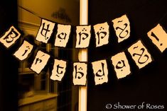 a happy birthday banner hanging from the side of a door with letters and numbers on it