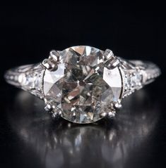 Vintage 1900's Platinum H SI2 Transitional Diamond Engagement Ring 3.10ctw 3.95gMetal Information: .900 PlatinumTotal Weight: 3.95gBand Width: 1.40mmSize: 6.75Circa: 1900'sAdditional Information: Girdle Abraded / Shows WearStone InformationMain StoneGem Type: DiamondShape: Transitional Round (9.3mm)Color: HClarity/Quality: SI2Carat Weight: 2.94ctNumber of Stones: 1Accent StonesGem Type: DiamondShape: Round (2.0mm)Color: HClarity/Quality: SI2Carat Weight: .03ctNumber of Stones: 4Accent StonesGem Antique Gia Certified Diamond Ring, Antique Gia Certified Wedding Jewelry, Antique Gia Certified Diamond Wedding Ring, Antique Style Gia Certified Diamond Wedding Ring, Jewelry Website, Custom Jewelry Design, Beautiful One, Estate Jewelry, Diamond Engagement Ring