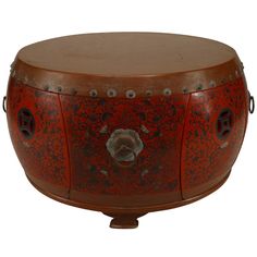 an ornately decorated wooden drum with metal fittings