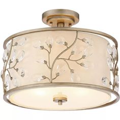 a semi - flush ceiling light with an etched glass flower design on the drum shade