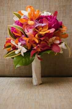 a bouquet of flowers sitting on top of a couch