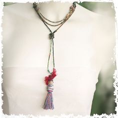 This versatile necklace can be worn with or without the stunning tassel pendant. Keep it long or wrap it around the neck or remove the pendant and wrap it around the wrist. The unusual pendant is made from my hand-rolled paper beads capped with a patinaed green Greek bead and wire-wrapped sari silk on top of that. It's a tribal-vibe look that complements the eclectic mix of beads in the long necklace. I made a silver swirled clasp to finish the look. The pendant slides off easily so that the necklace can also be worn as a wrap bracelet. ←→ LENGTH: 34" long, Tassel pendant adds about 4"   ❦ All my jewelry comes in a cute linen pouch or a pretty pillow box. If some of your items are gifts let me know and I will wrap them separately. ✦I am so glad you visited RocksandPaperSwans ... And thanks Handmade Lariat Tassel Necklace, Adjustable Lariat Long Necklace For Festival, Bohemian Lariat Necklace With Tassels, Unique Lariat Necklaces For Festival, Bohemian Lariat Necklace As Gift, Bohemian Lariat Necklace For Meditation, Unique Lariat Necklace For Festivals, Unique Lariat Necklace For Festival, Handmade Tassel Necklace As Gift