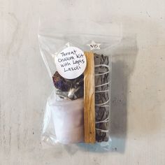 a packaged package of cookies and other items on a white table top with a wooden stick sticking out of it